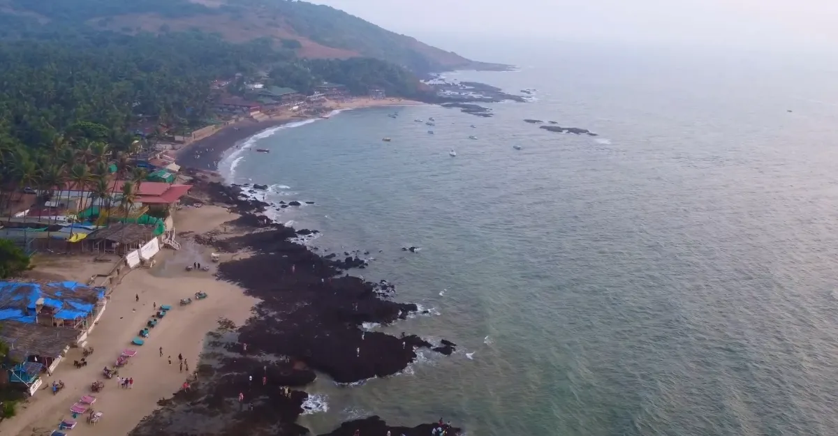 Overhead shot of Anjuna Beach and a resort, highlighting the calm waters and soft sands, making you wonder why you feel so relaxed.