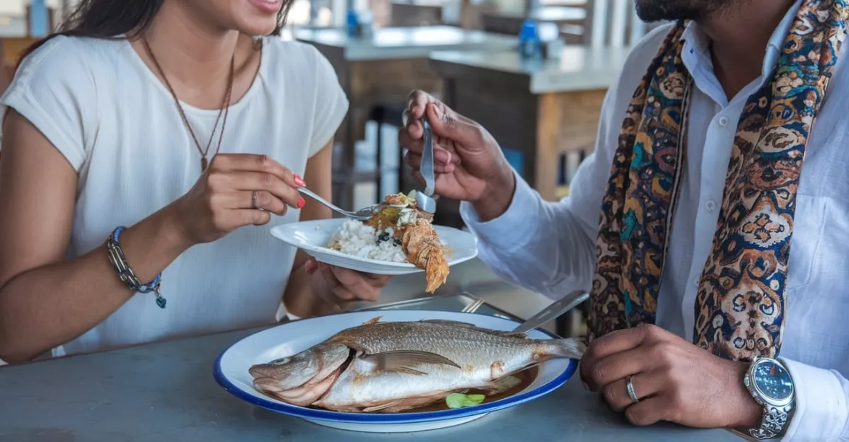 Fish Recheado served with rice on a dining table, with two individuals enjoying the meal.